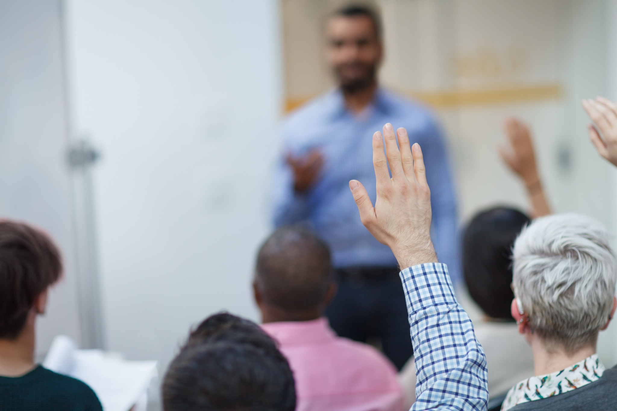 Community meeting with raised hands